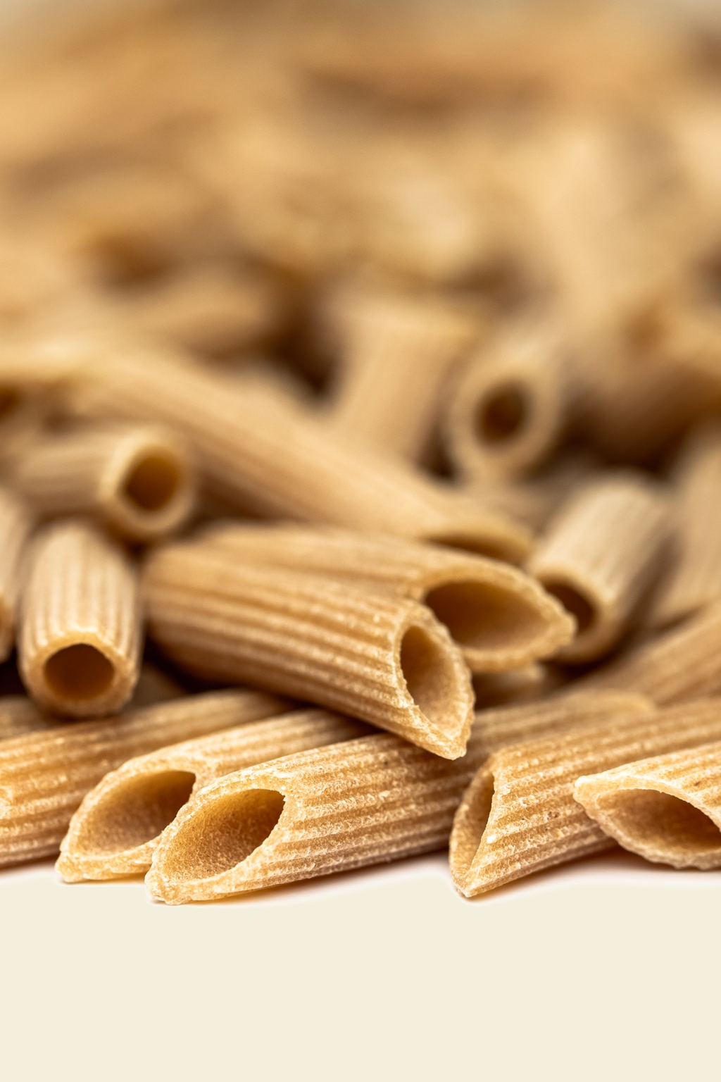 Whole Wheat Penne Rigate — penne_integrali_macro_F4EFDD.png